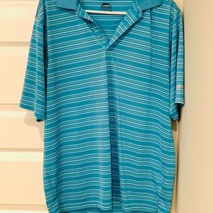 Men’s blue and white Slazenger dry fit golf polo.